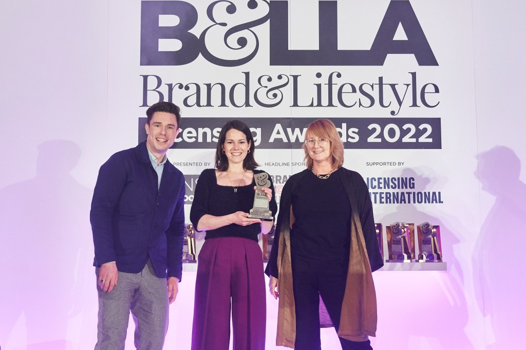 Above: A2V’s licensing manger Josie Will was presented with the Best Brand Licensed Gifting Product or Range, for the company’s Joules Crafting Range, by Hearst’s head of lifestyle licensing, Lou McArthur, category sponsor. On the left Awards host Ed Gamble.